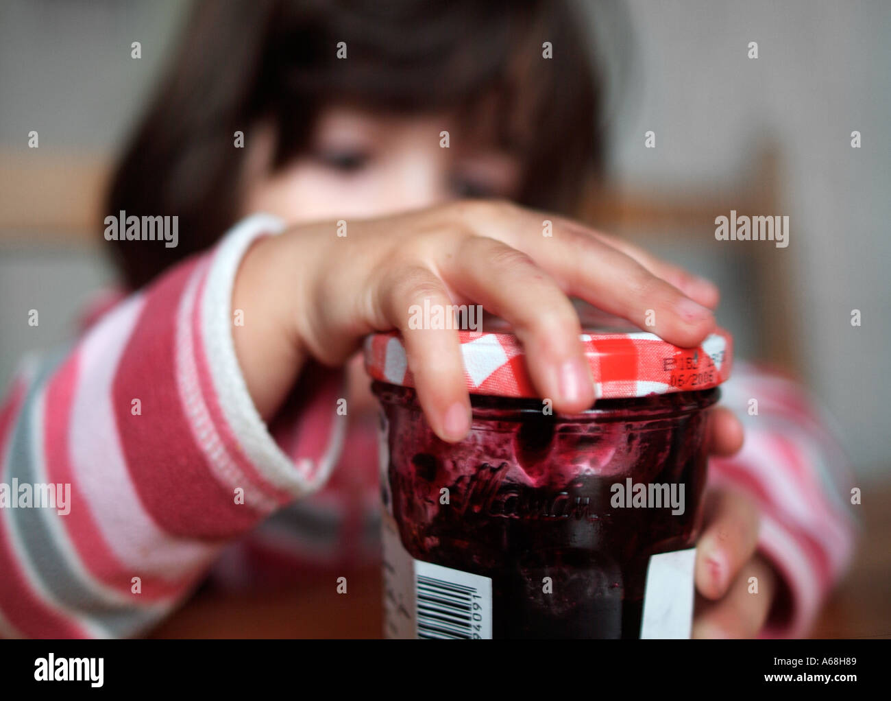 Child opening a jar of jam Stock Photo Alamy