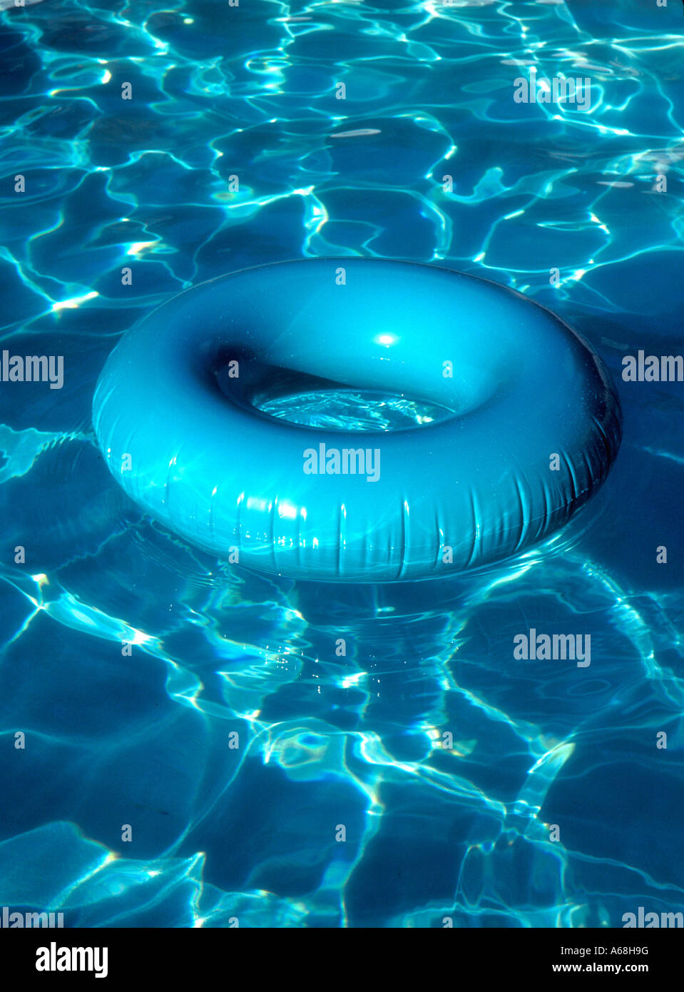 Aqua innertube with pool reflections Stock Photo - Alamy