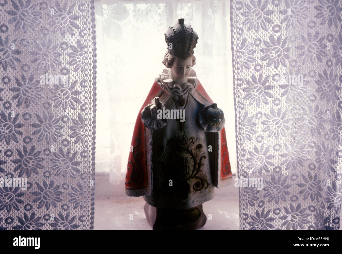 Infant of Prague statue in an Irish home with lace curtains Ireland Stock Photo