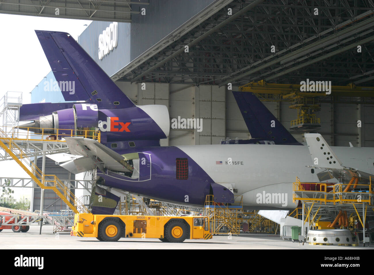 A FedEx cargo aircraft undergoes maintenance at a maintenance facility hangar at Changi Airport, Singapore. Stock Photo