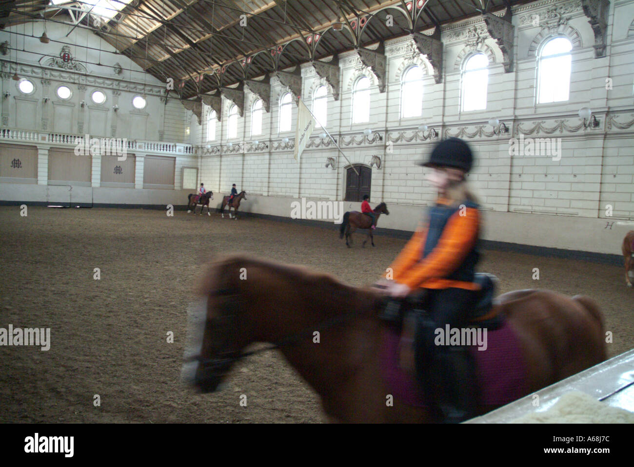 young girl at horse riding school manege stable Stock Photo - Alamy