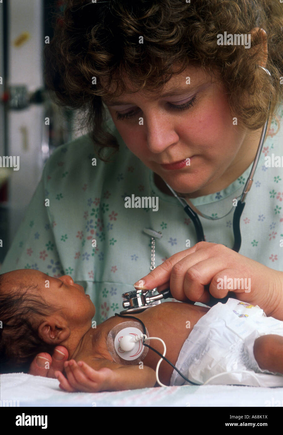 Premature infant in intensive care unit. Stock Photo