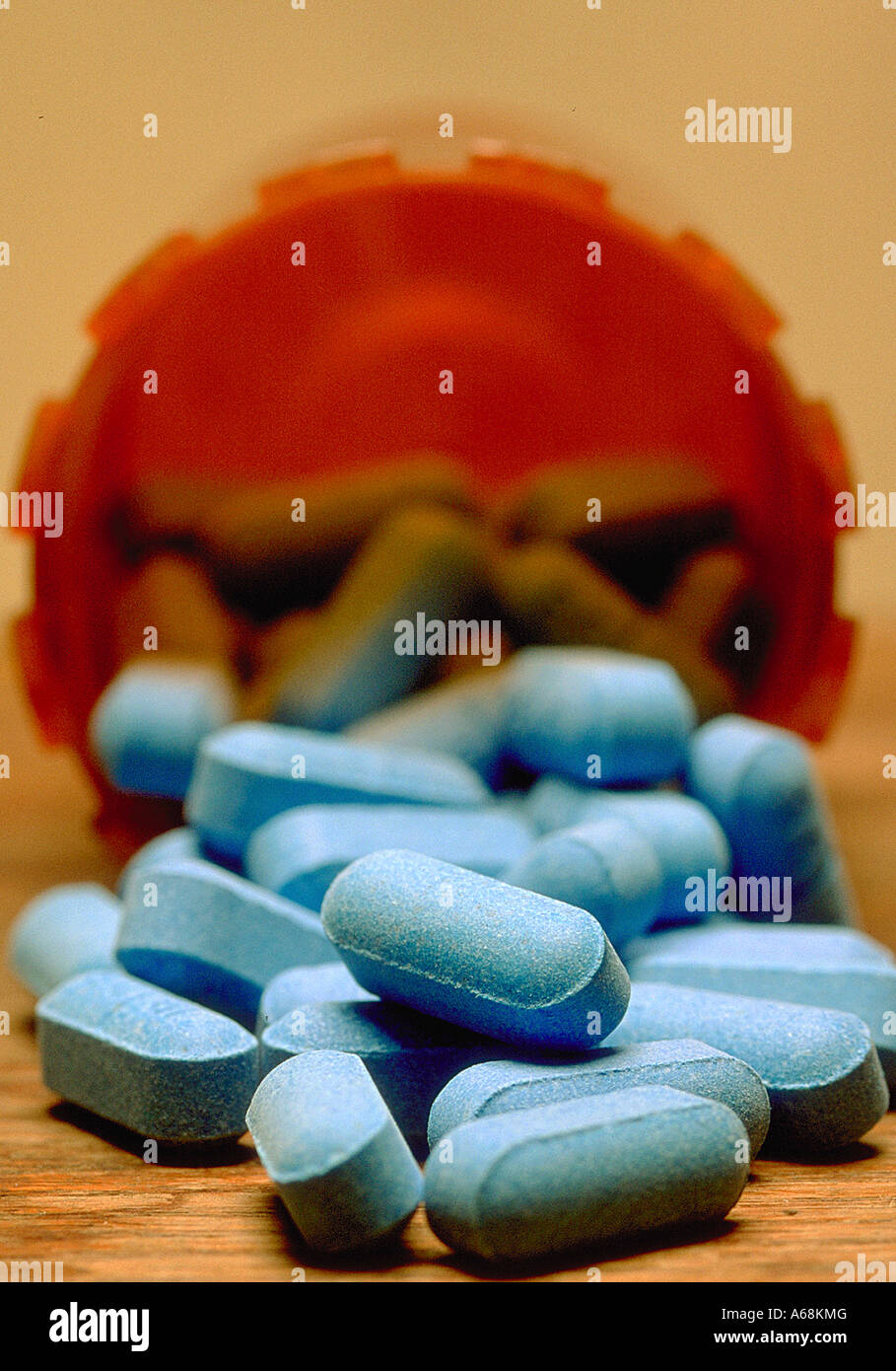 Blue pills spill out of prescription drug bottle Stock Photo