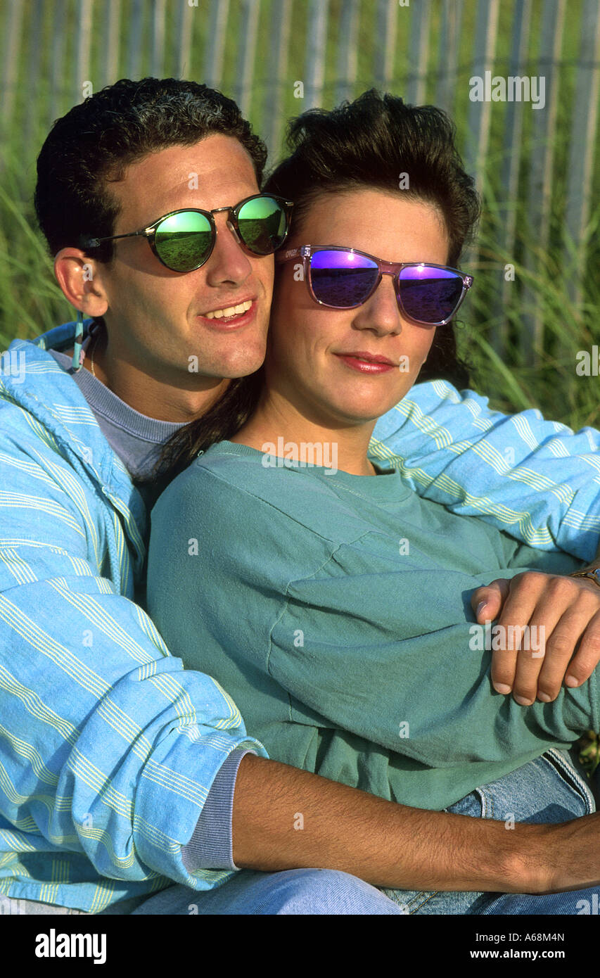 Young couple enjoy time together as they watch the sunset Stock Photo