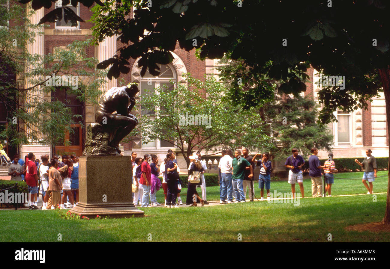 Black high school students passing Rodan's The Thinker on the Columbia University Campus. New York New York USA Stock Photo