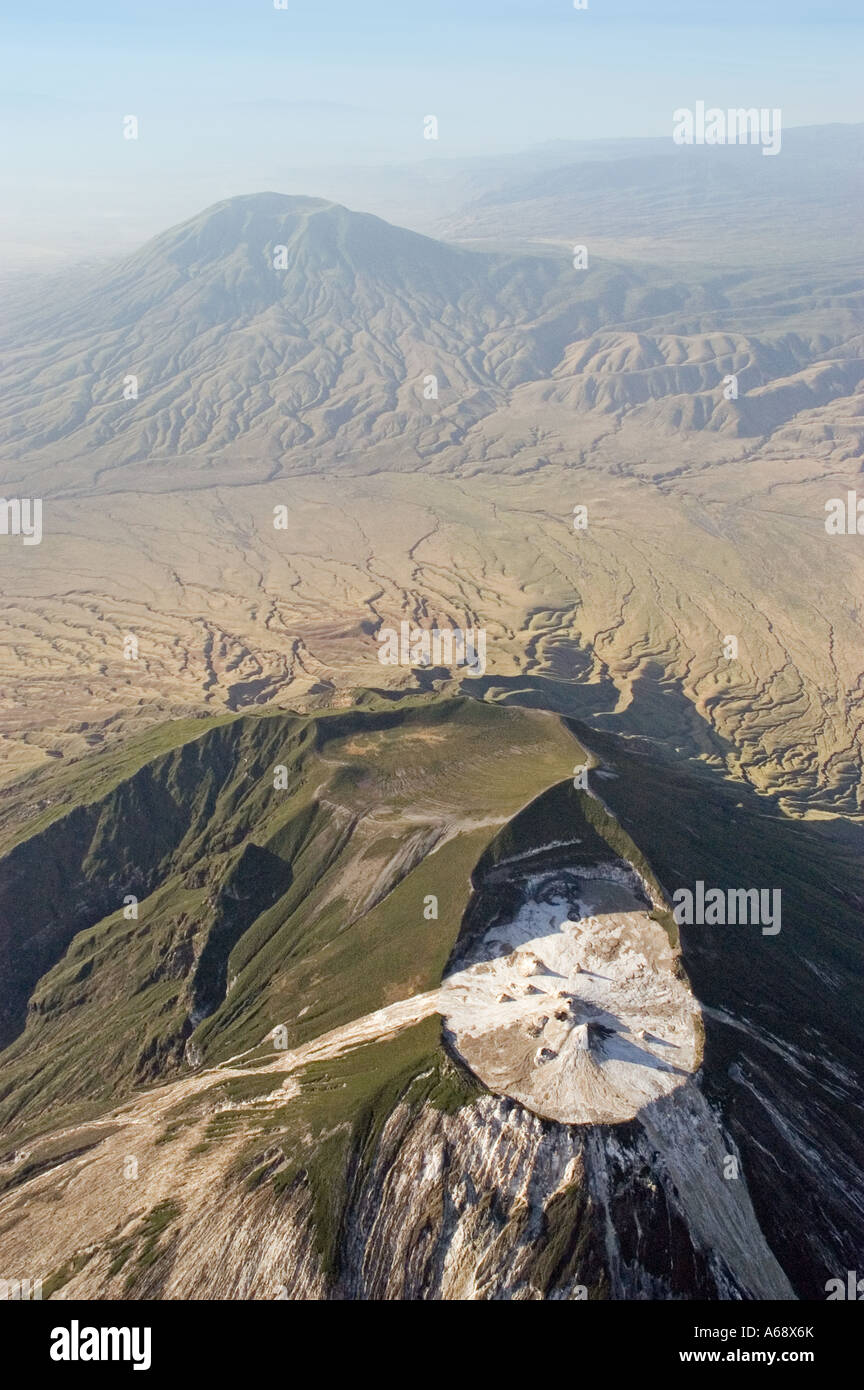 Ol Doinyo Lengai, panoramic aerial view of the cone and crater with the extinct volcano Keremassi in the background, Tanzania Stock Photo