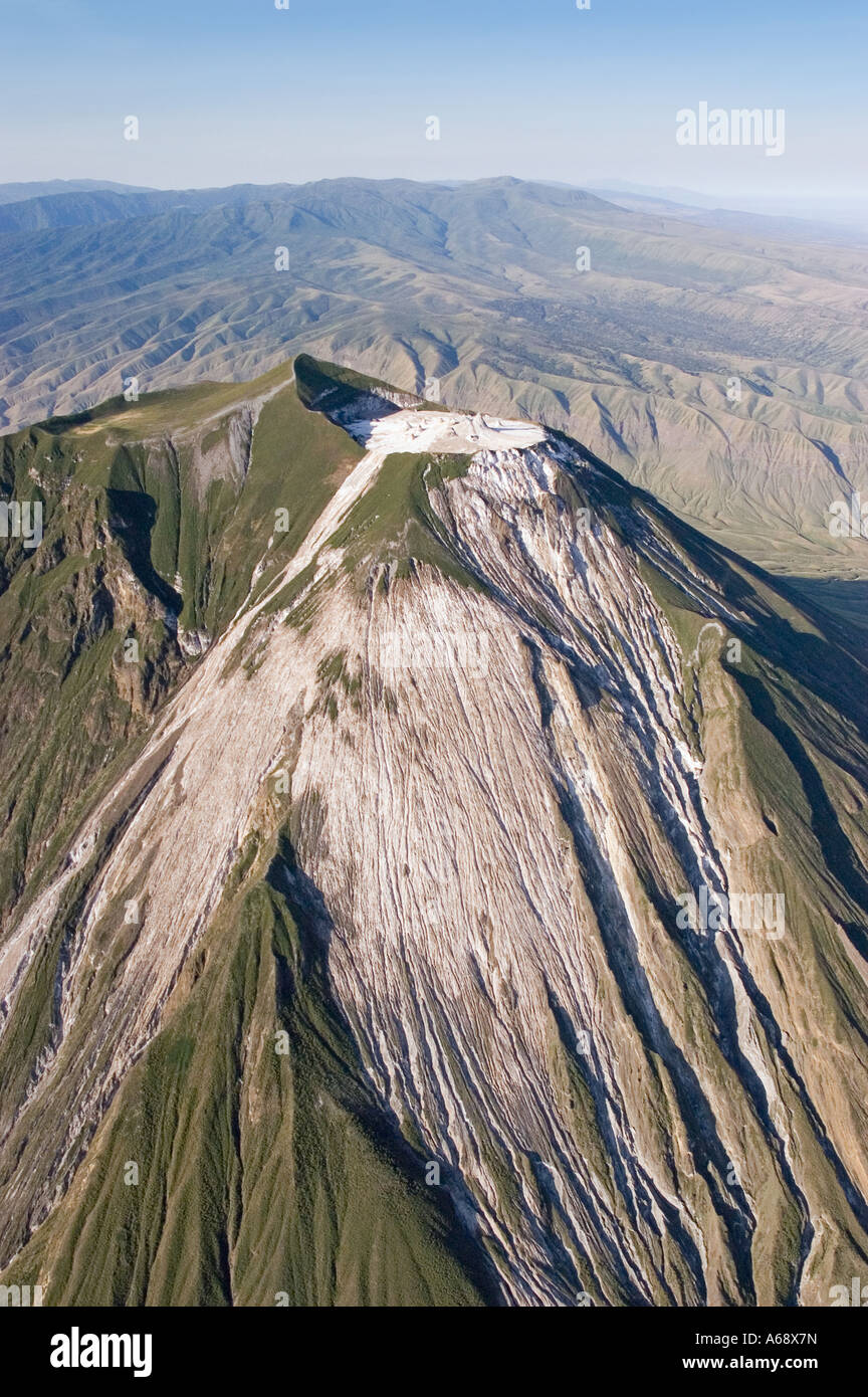 Ol Doinyo Lengai, aerial view of the cone and crater with the African Rift Valley in the back ground, Tanzania Stock Photo