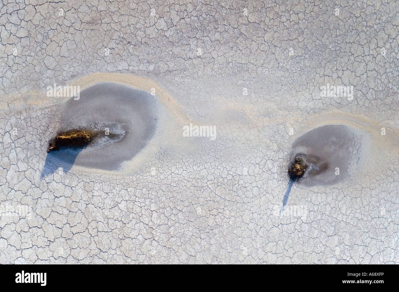 Aerial view of two rocks surrounded by dried salty mud of Lake Natron, Tanzania Stock Photo