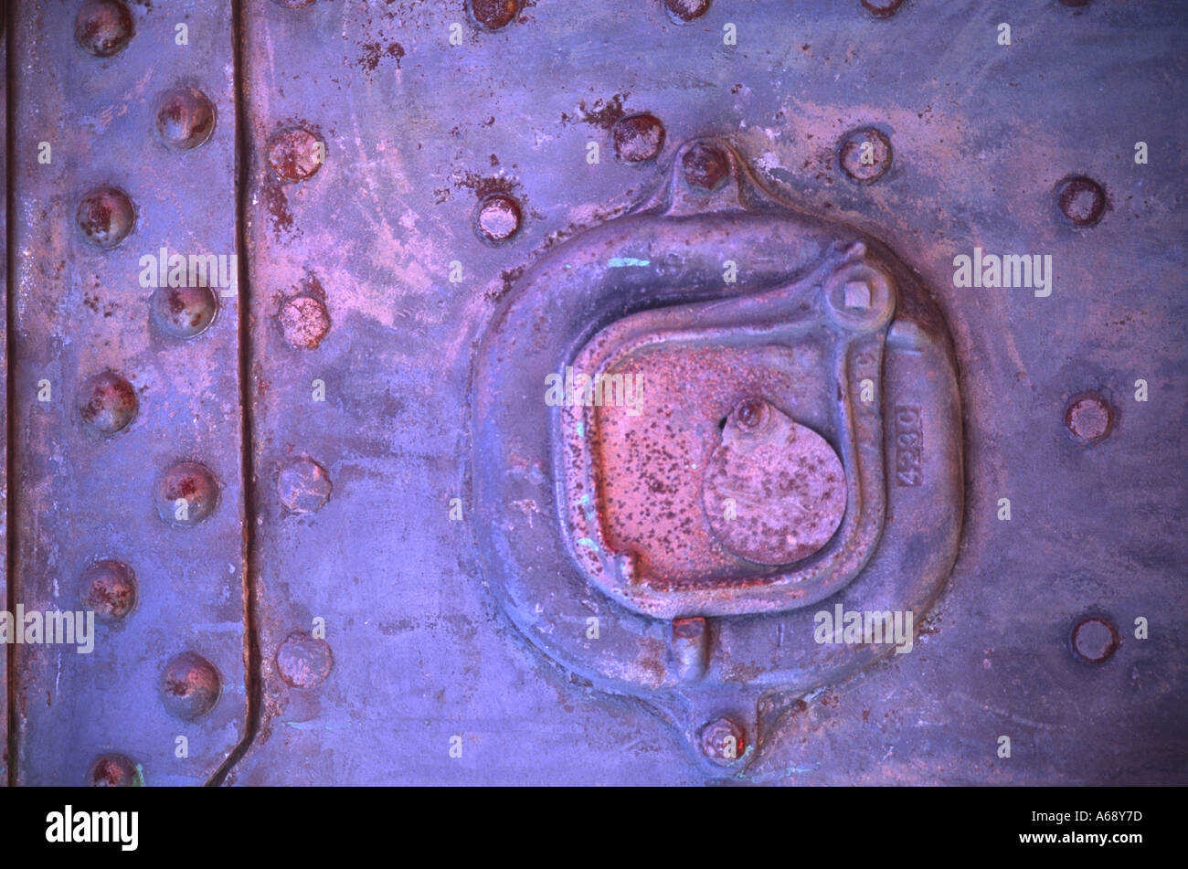 Detail of rivets and rust on the boiler of an antique steam tractor ...