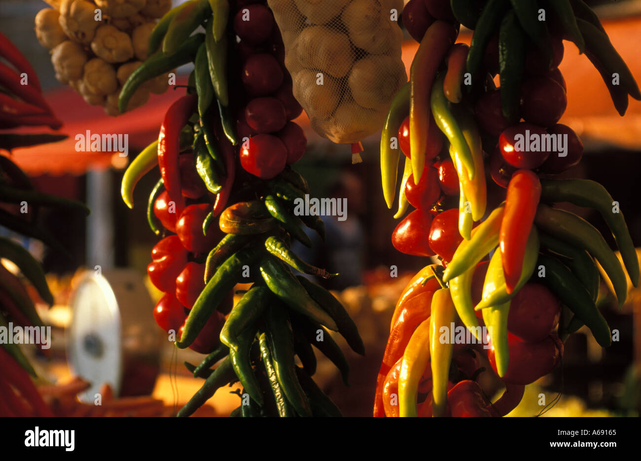 Chillies and Garlic hanging in market nr Rialto Venice Italy Stock Photo