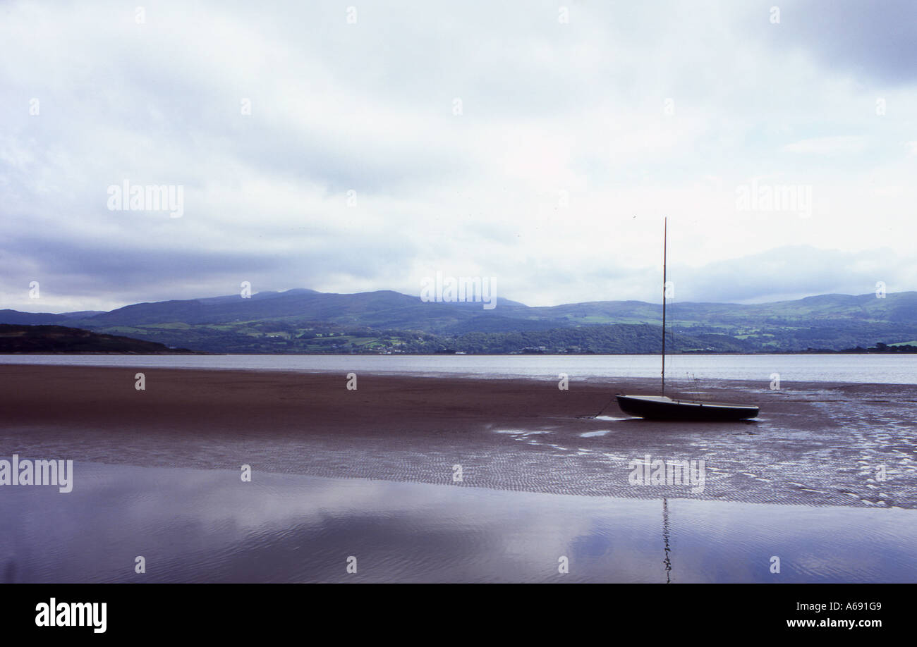 beached yacht at portmeirion with backdrop of snowdonia number 2308 Stock Photo