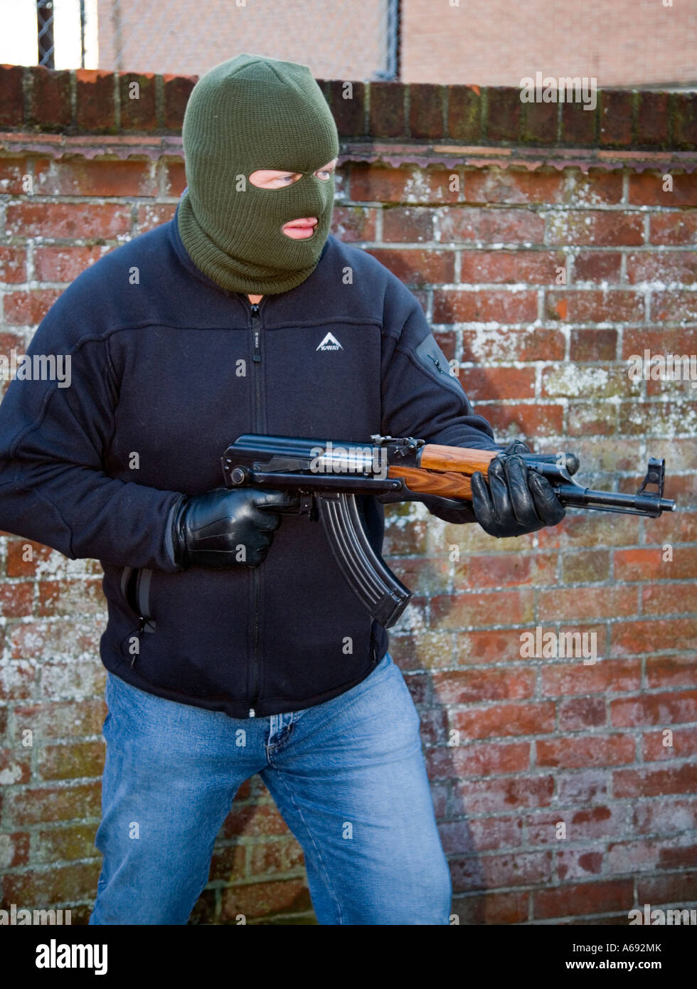 Masked arm robber  / terrorist with Chinese AK47 assault rifle Stock Photo