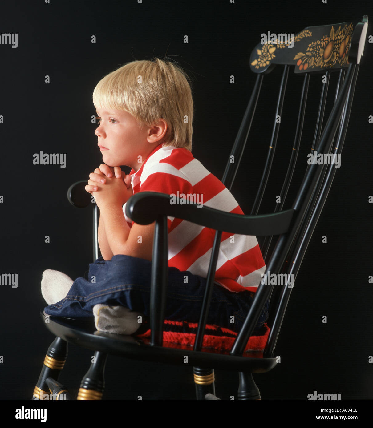 Boy watching TV from rocking chair Stock Photo Alamy