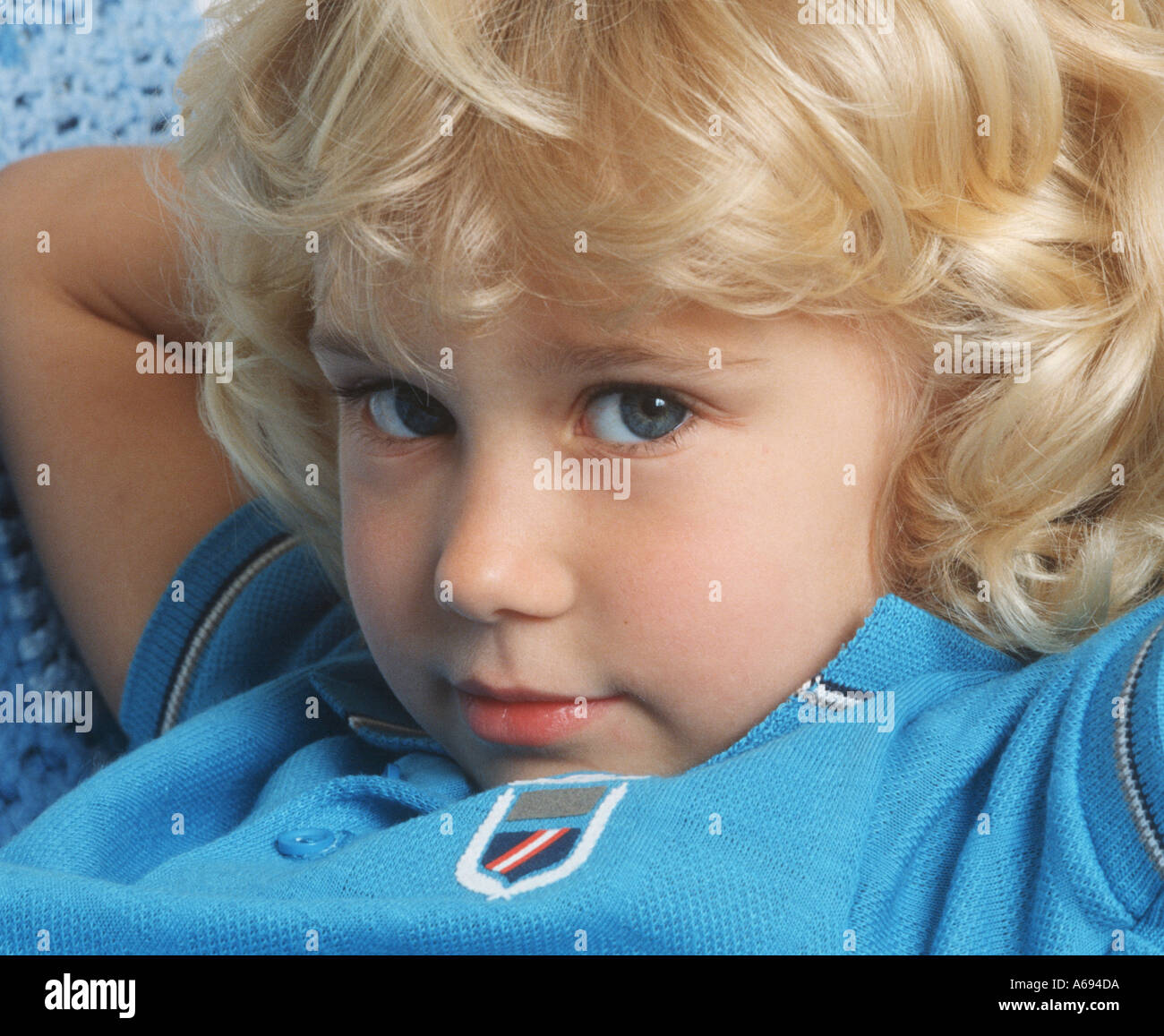 Small blond girl relaxing on couch closeup Stock Photo
