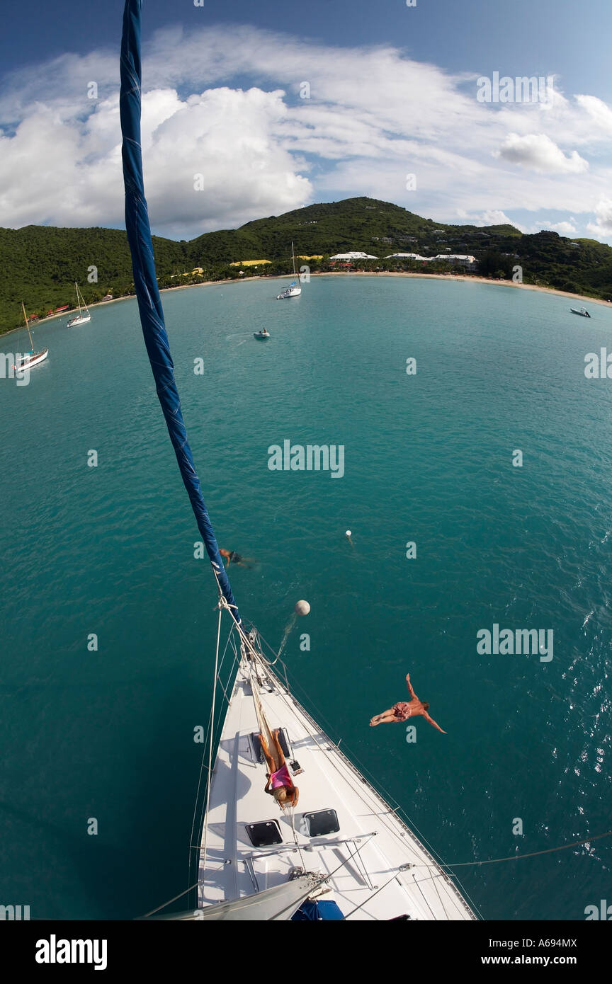 man diving from sail boat in St. Martin, leeward, islands Stock Photo