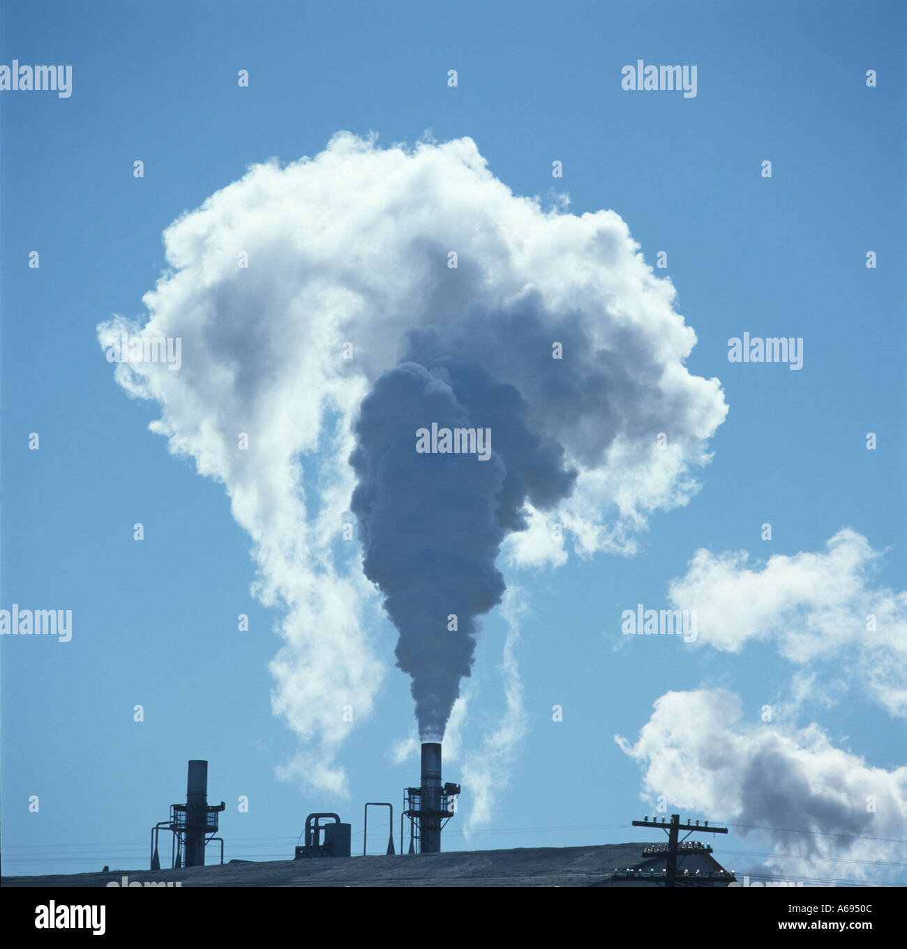 Smoke from a power plant chimney stack Stock Photo