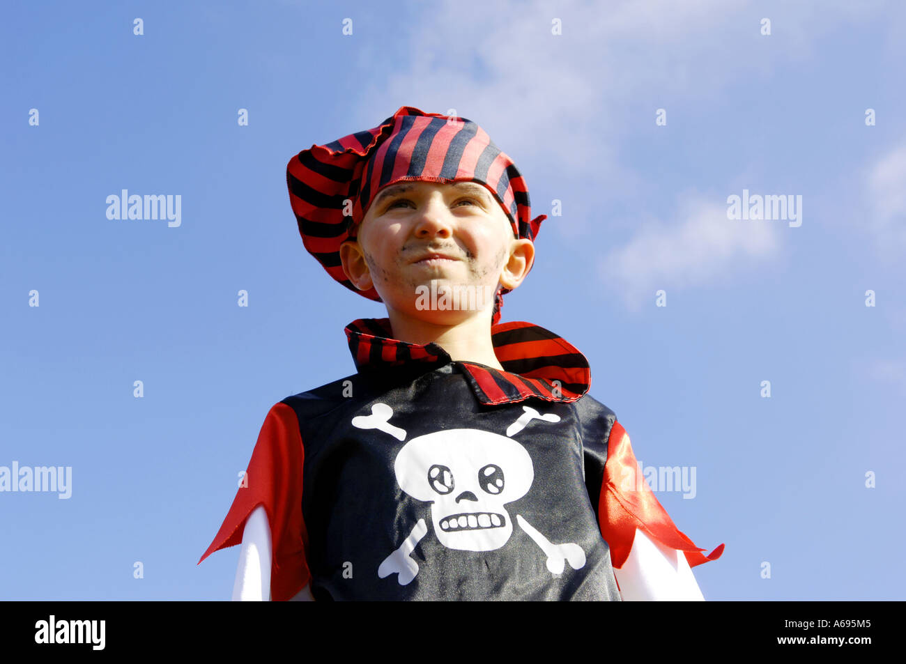 bandana face head portrait pirate expressive red black skull and crossbones  preteen blue sky boy male pose karneval carnival fan Stock Photo - Alamy