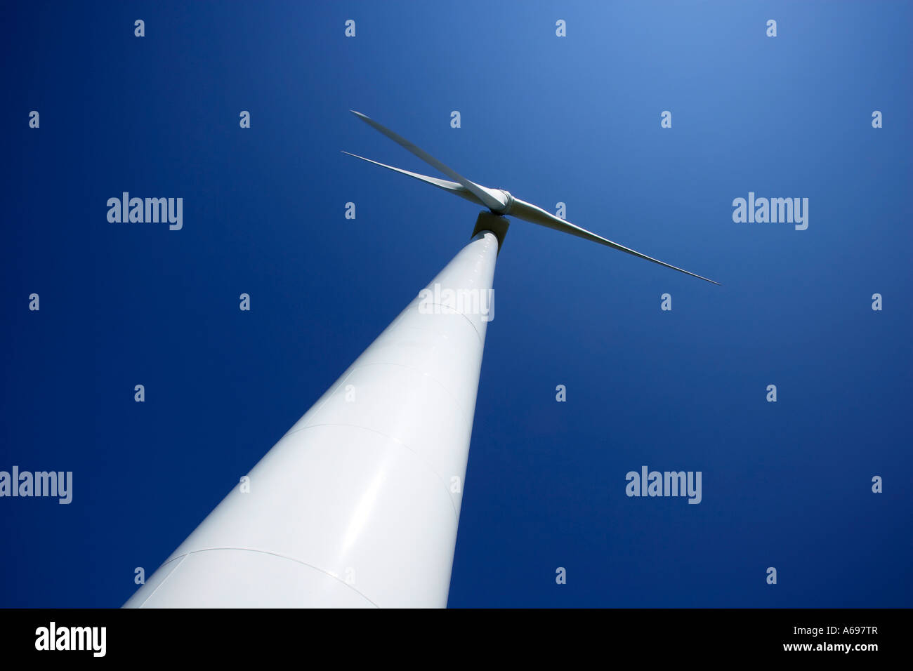 Wind power turbine against blue sky Stock Photo - Alamy