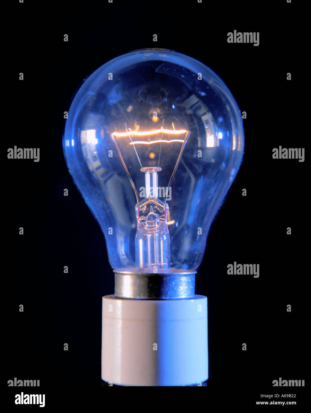 Domestic electric light bulb showing lit tungsten filament, UK Stock