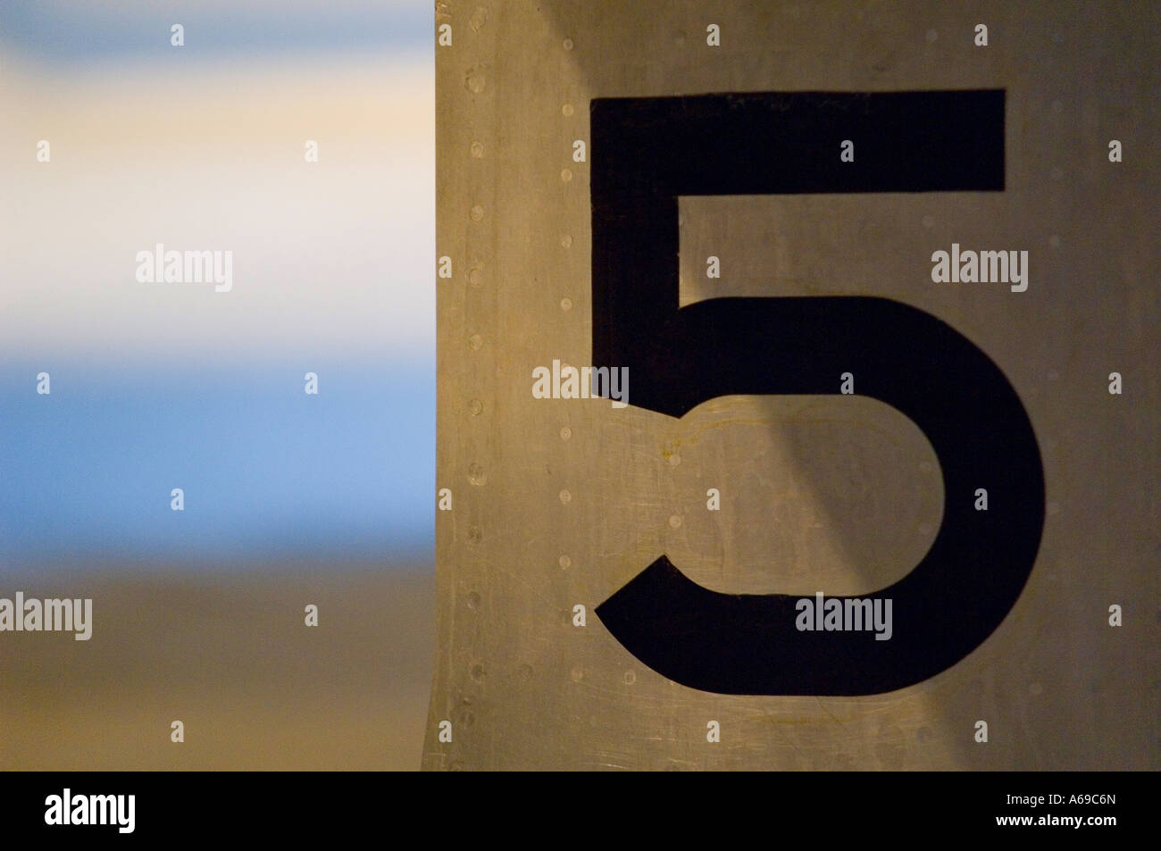 Number 5 painted on metal surface. Stock Photo