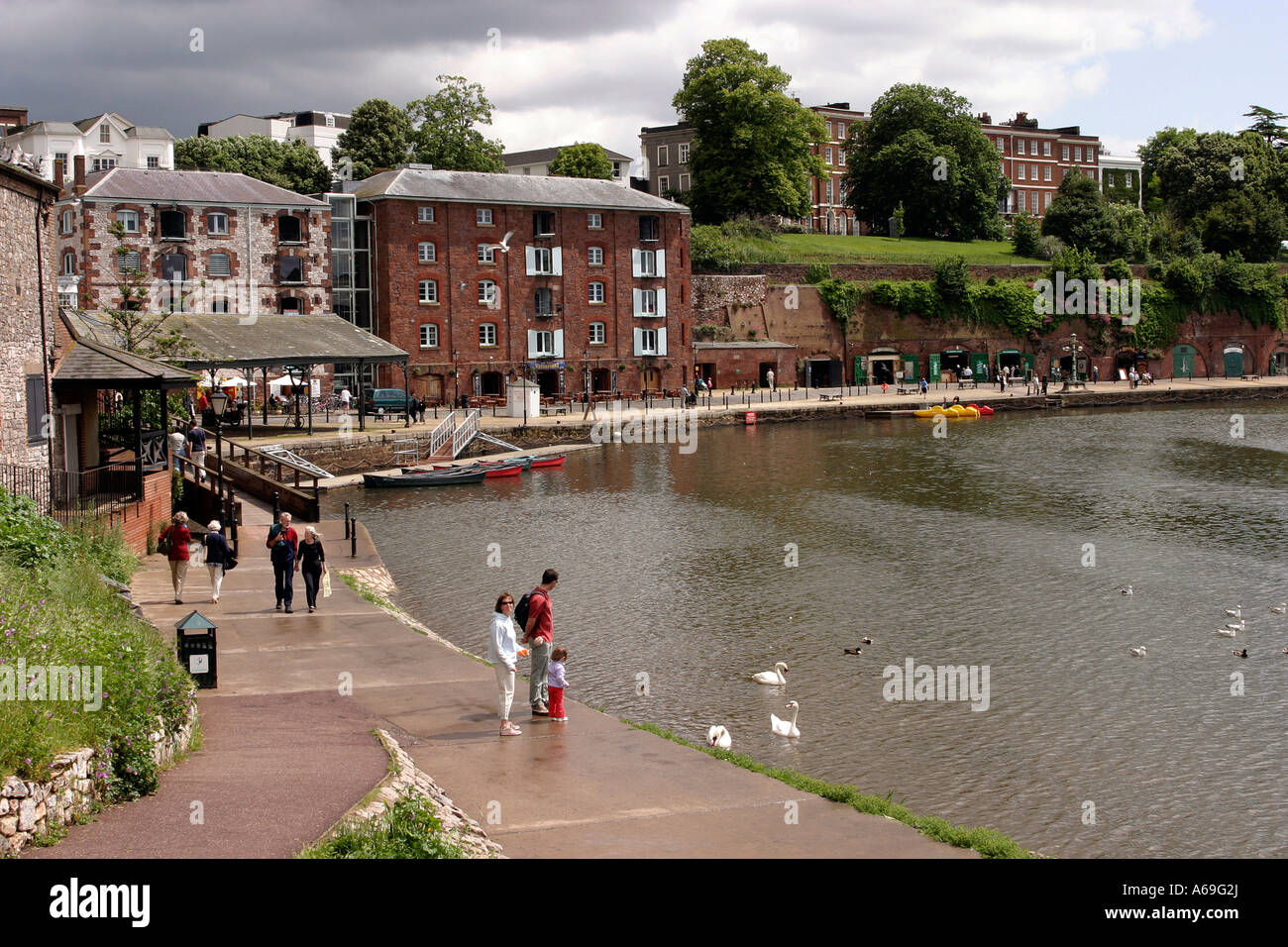 UK Devon Exeter River Exe Quayside vistors walking along riverside path