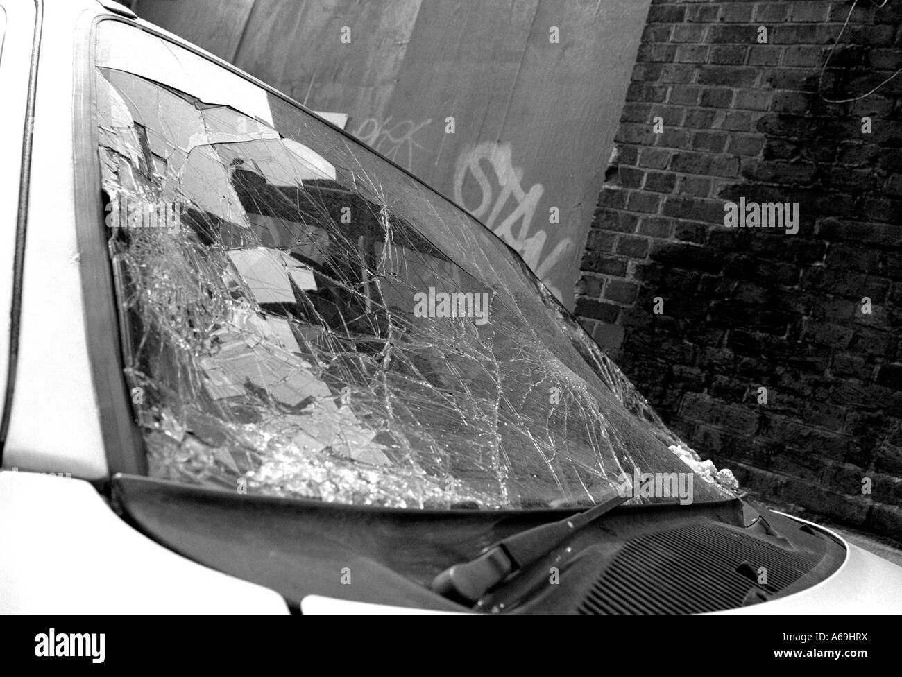 Vandalised car with smashed windscreen on London street Stock Photo