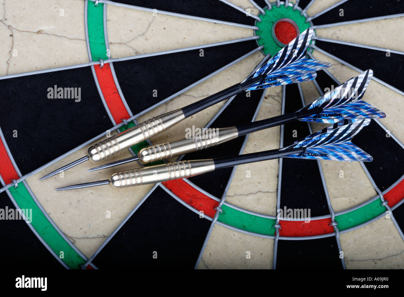 Three darts on a dartboard Game of throwing darts at a target Stock