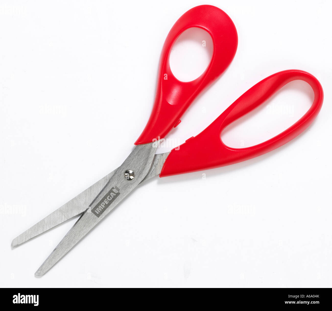 scissors slightly open with a red handle on a white background Stock Photo