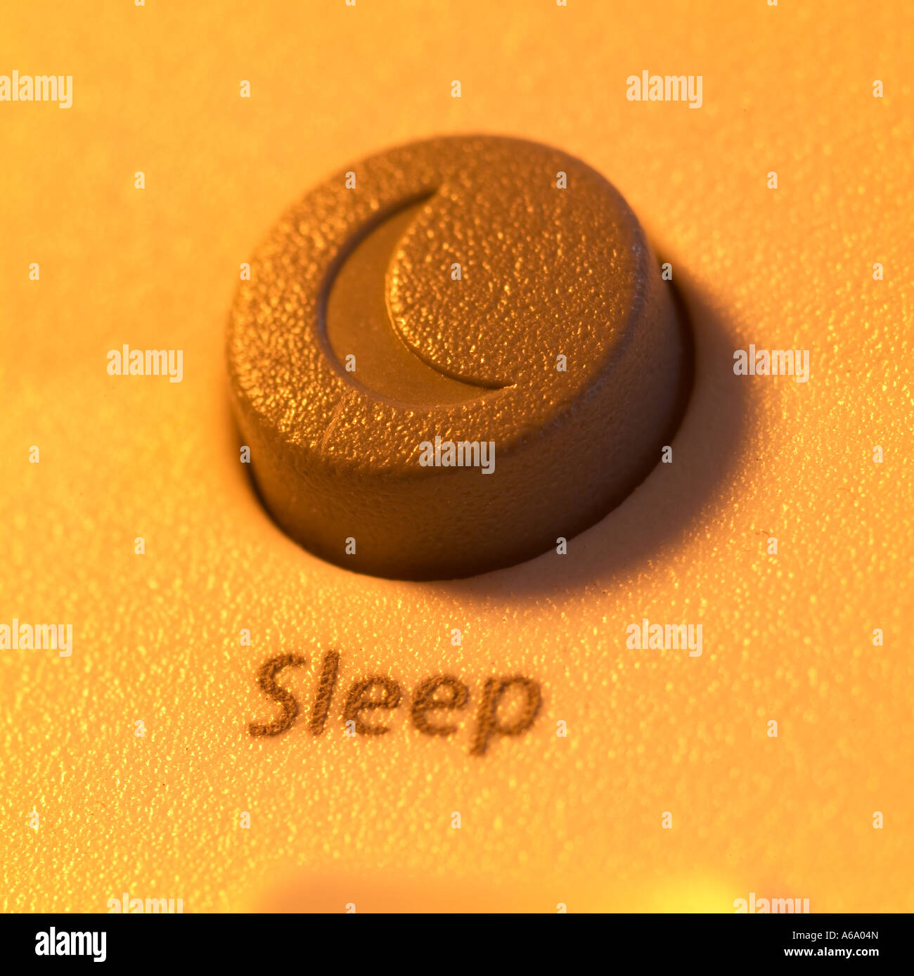 sleep icon from a computer keyboard with a warm orange glow Stock Photo