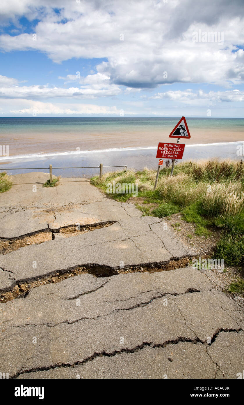 Seaside Road and warning signs in Aldbrough, Yorkshire, UK. Erosion along the North Sea coastline. Stock Photo