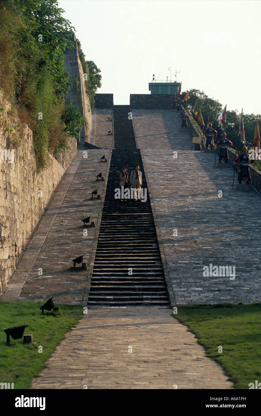 China, Jiangsu, Nanjing, Zhonghua Gate, visitors on steps of wide stonework ramp, lined with statues of soldiers Stock Photo