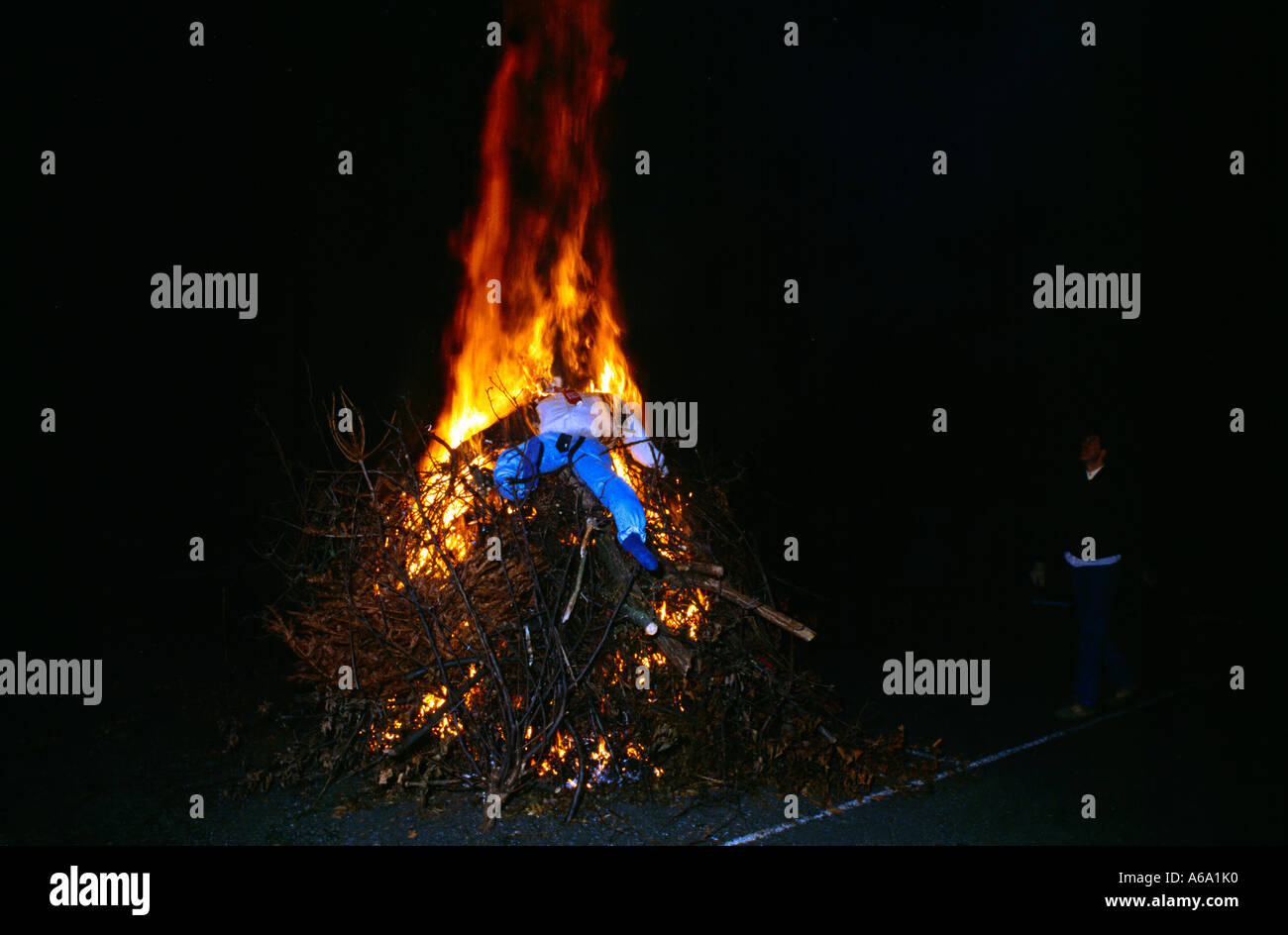 Guy Fawkes Guy On Top Of Lighted Bonfire Stock Photo