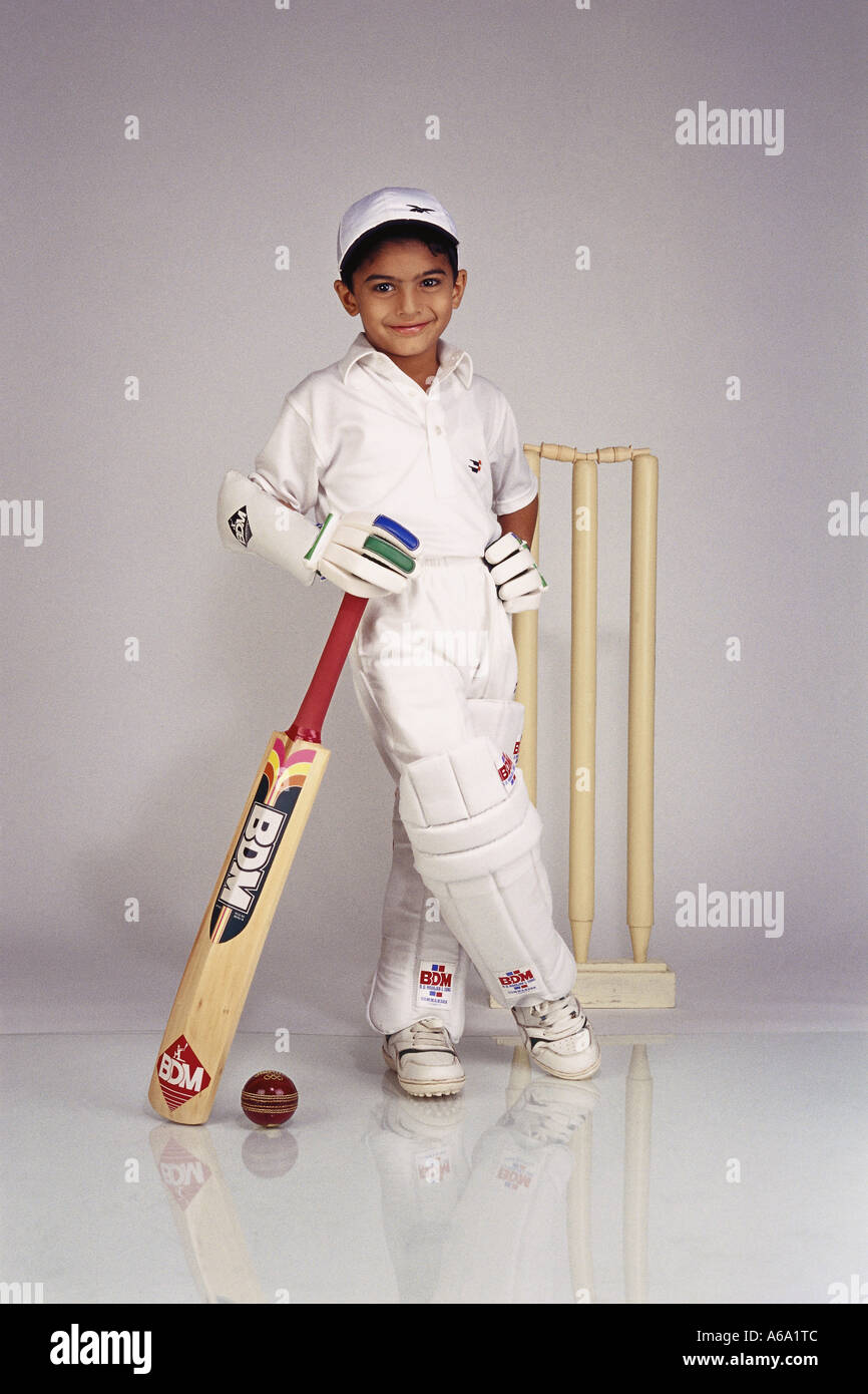Indian child fancy dress in cricket dress boy In full cricketing gear full figure shot - Model Release # 494 Stock Photo