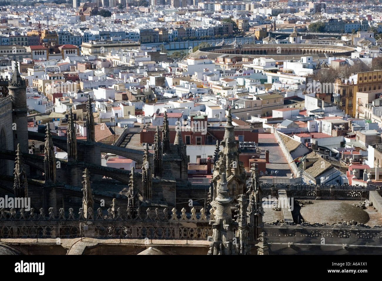 The roof of Seville's cathedral with Maestranza bullring on background as seen looking westward from Giralda tower Stock Photo