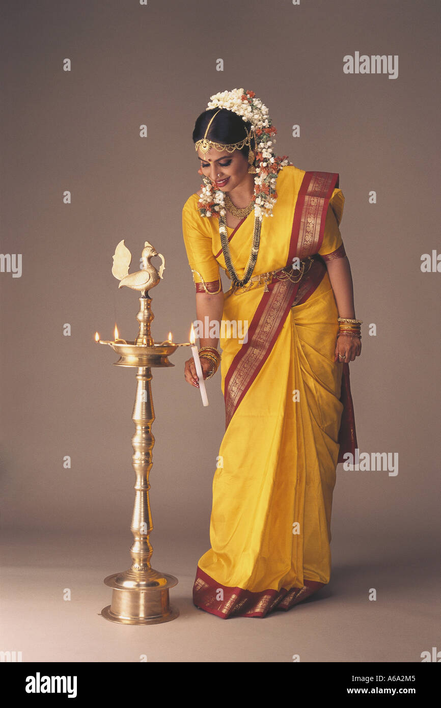 VDA77158 South Indian Bride Dressed In Traditional Bridal Costume Full Figure Lighting A Traditional Lamp MR#119 Stock Photo