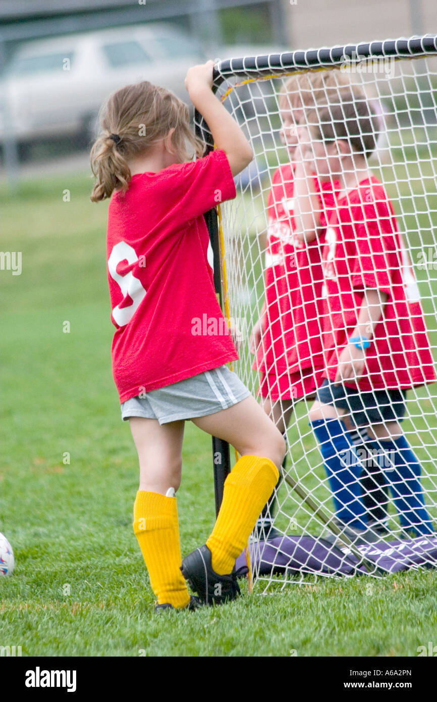 Soccer teammates age six talking by the goal during break. Carondelet Field by Expo School St Paul Minnesota USA Stock Photo