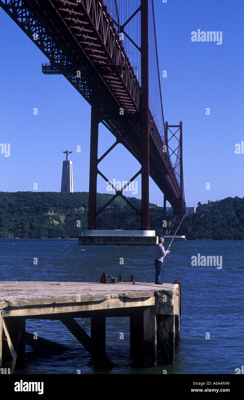 Ponte de 25 abril bridge of 25 th of april with the statue of Cristo Rei in the back ground Stock Photo