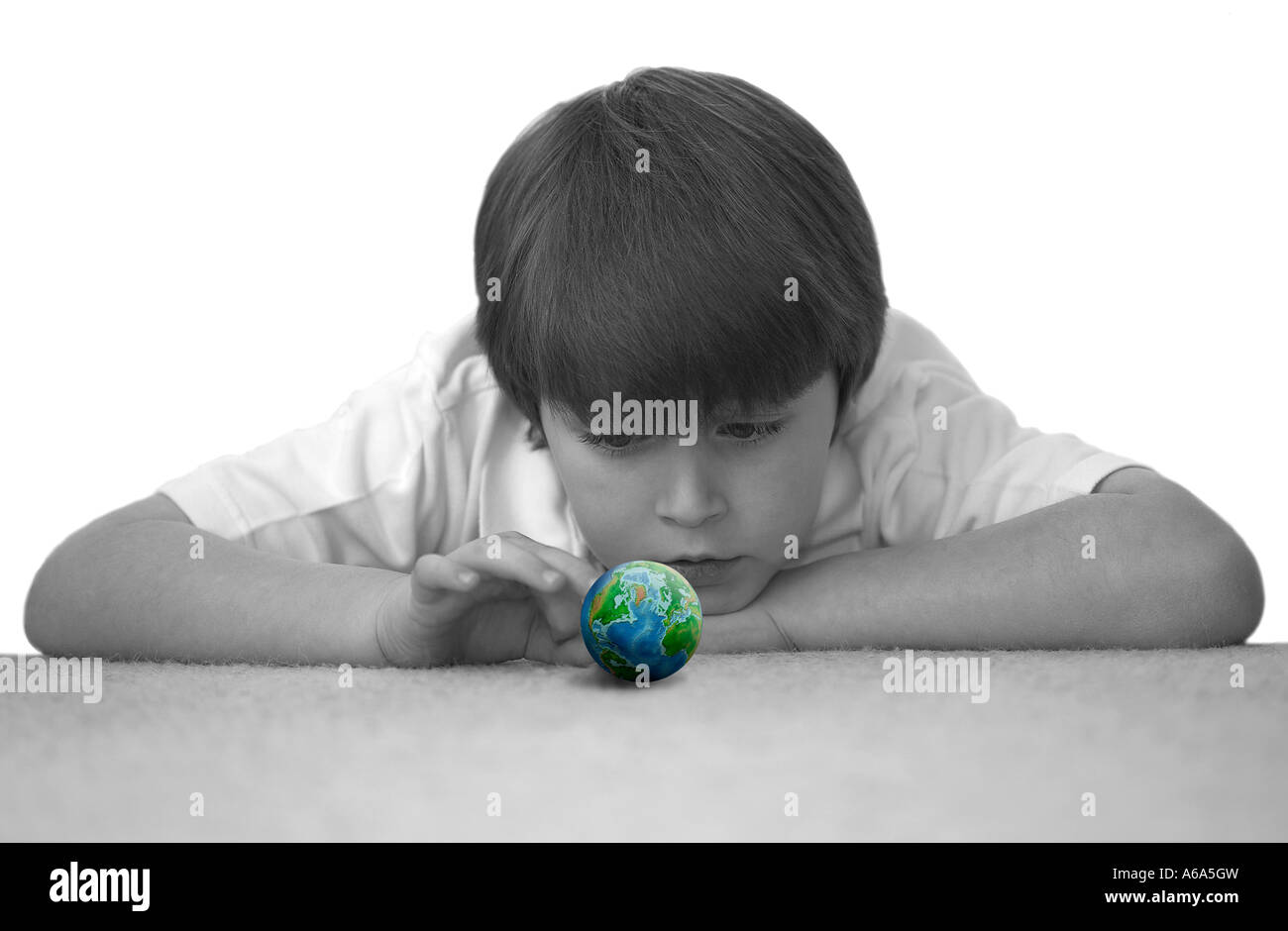 Black White concept image of a boy about to flick the world Stock Photo