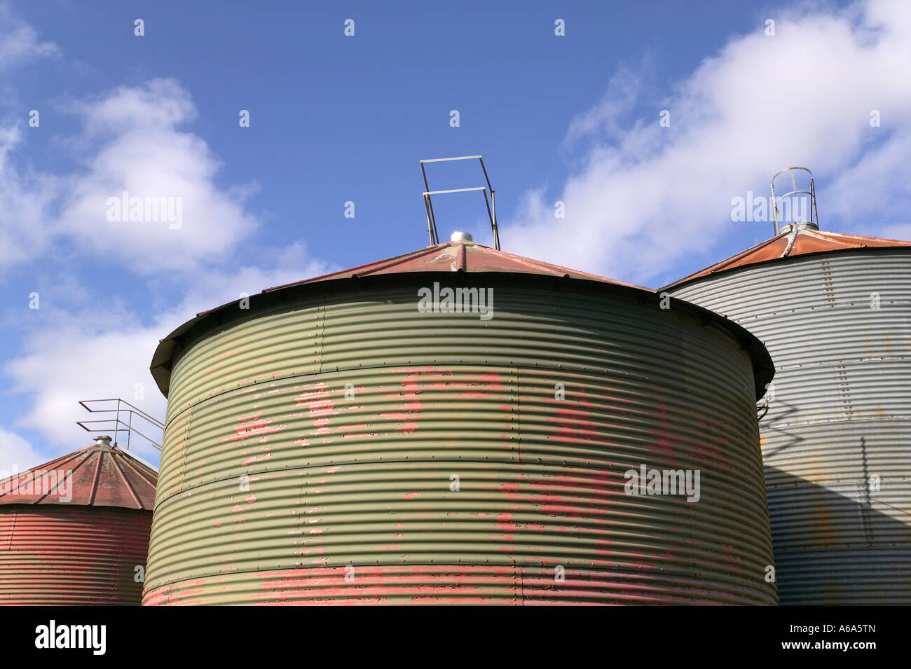 Grain drying silo against a blue sky Stock Photo