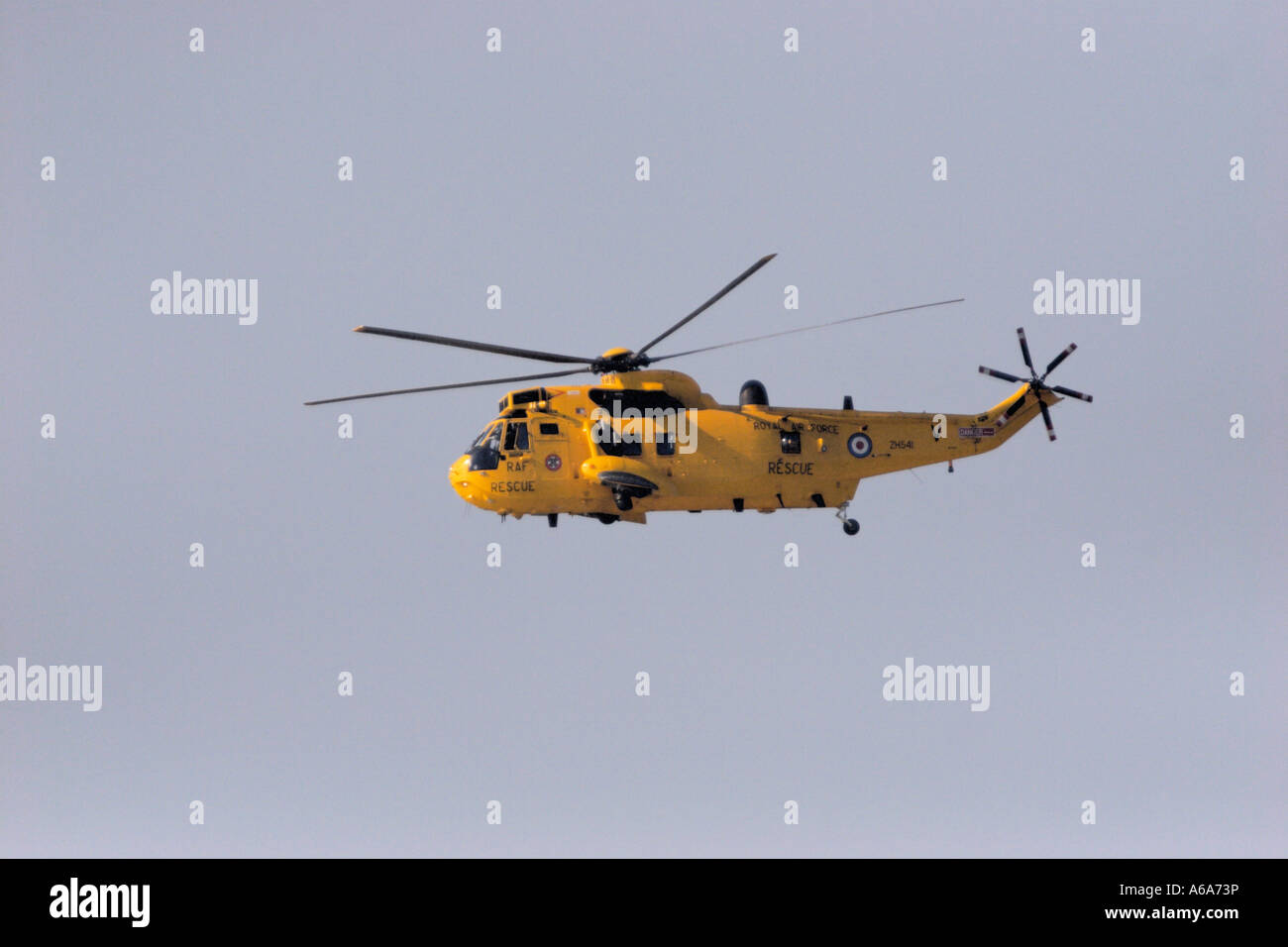 R.A.F. RESCUE HELICOPTER FLYING AGAINST A BLUE SKY Stock Photo