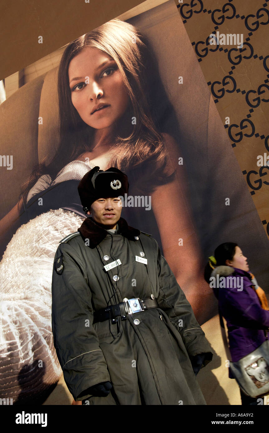 A security guard stands in front of a Gucci billboard in Beijing, China. 14  Dec 2005 Stock Photo - Alamy