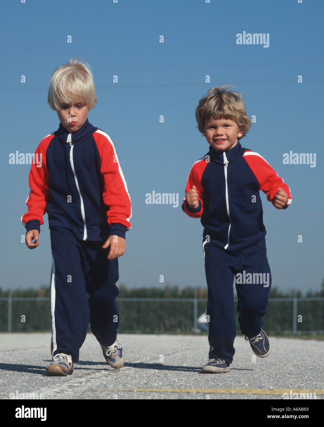 small boy and girl jogging on track Stock Photo