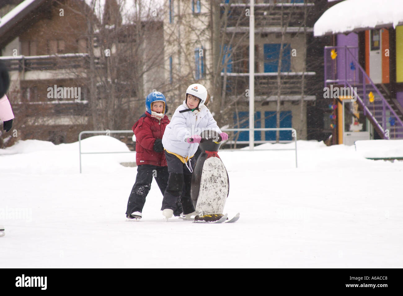 Children playing on skates on ice rink Zermatt Switzerland Stock Photo
