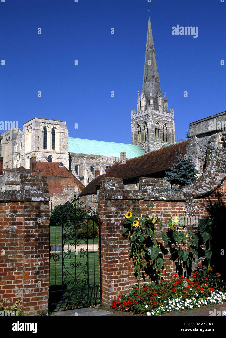 Chichester Cathedral spire and green patina copper roof over the nave a grade I listed building on a blue sky day in Chichester West Sussex England UK Stock Photo