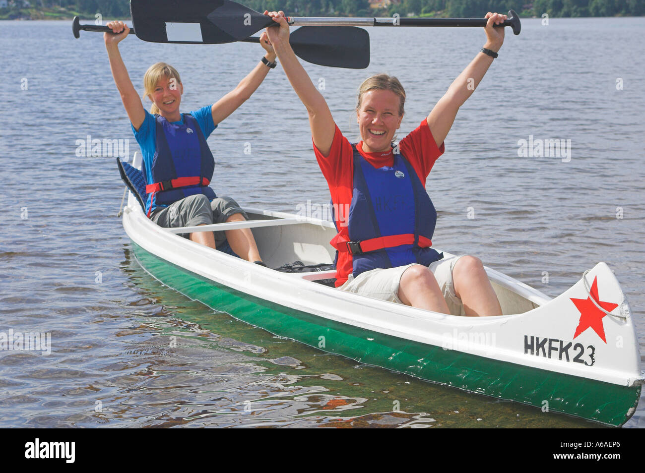 Happy girls sitting in a canoe Stock Photo - Alamy