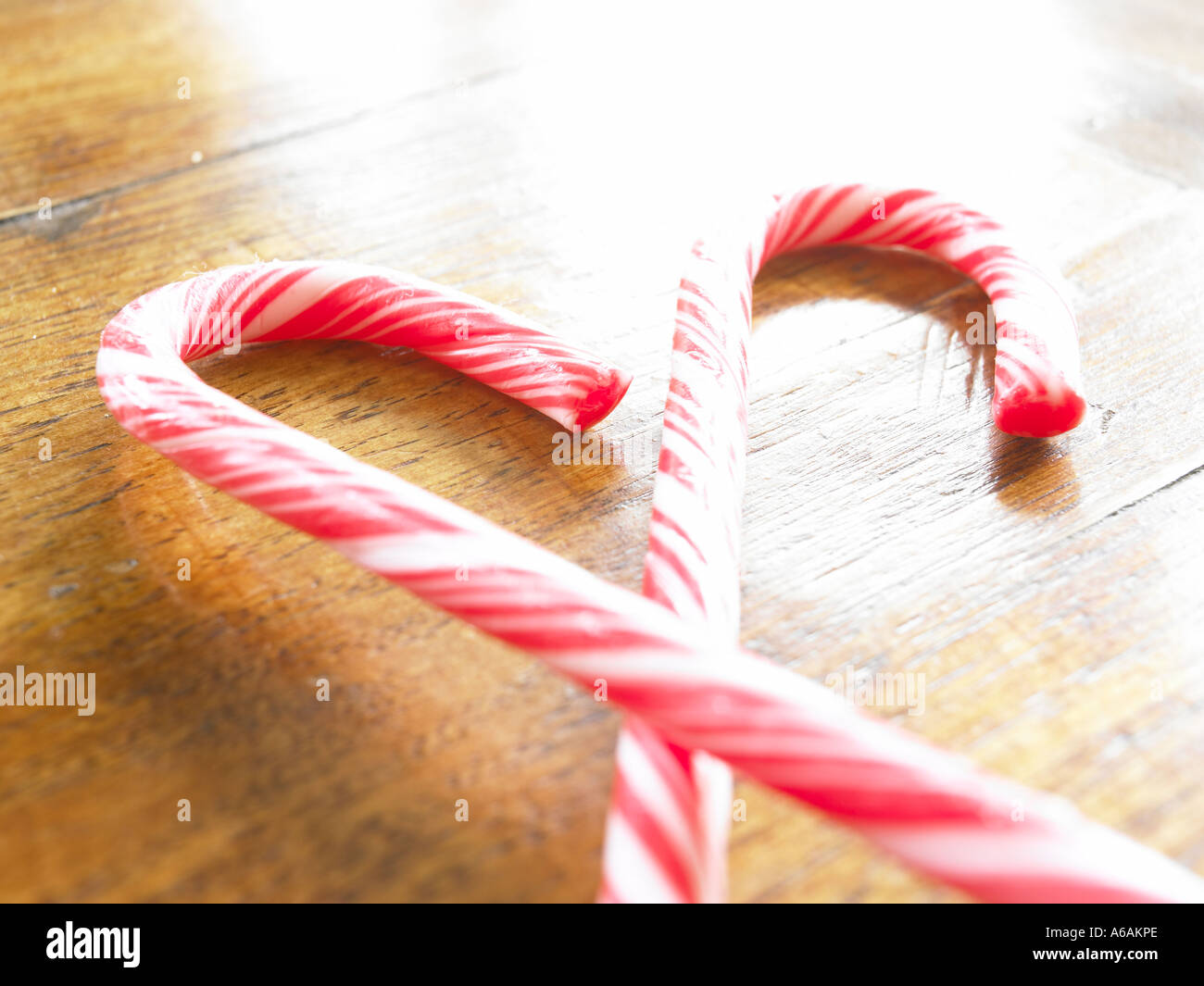 two red and white candy cane layed down crossing each other on top of ...
