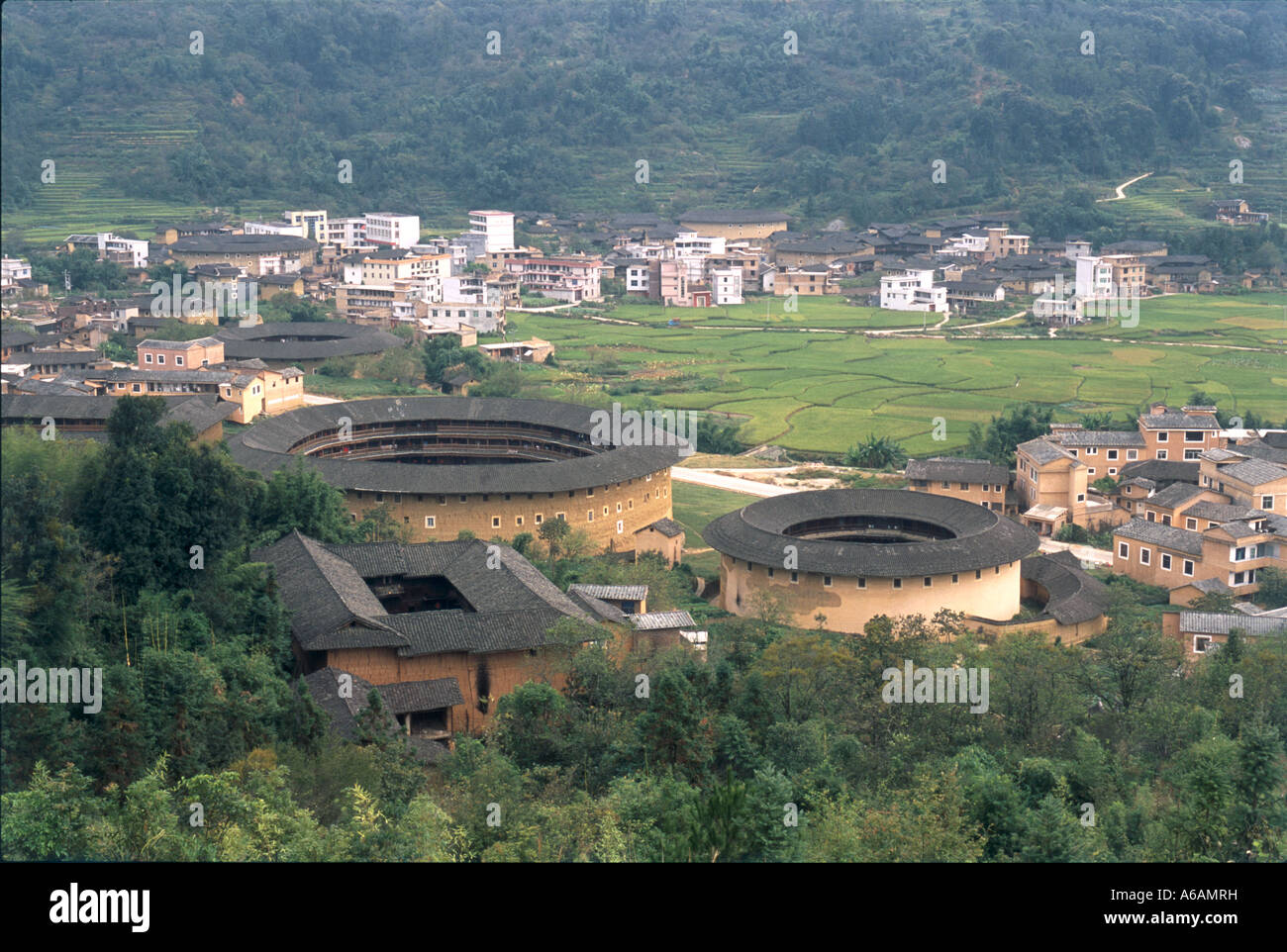 China, Fujian, outer walls of fortress, round and square dwellings housing Hakka people Stock Photo