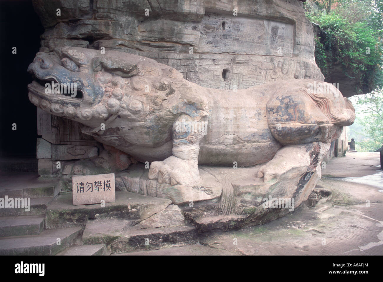China, Sichuan, Dazu, Baoding Shan, Cave Full Enlightenment 28, Stone Lion, twice life-sized statue lion guarding entrance Stock Photo
