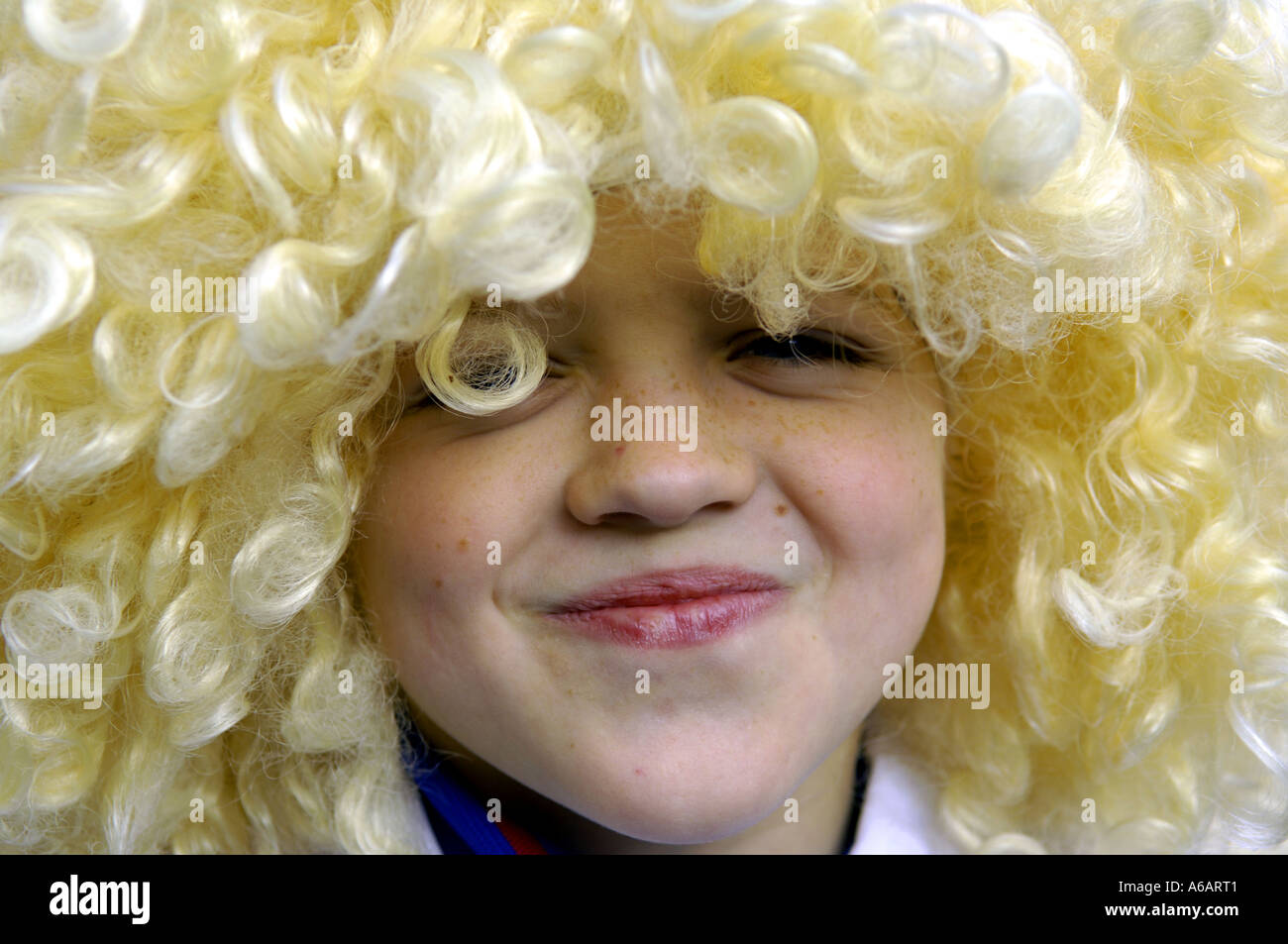boy blond blonde wig curly funny face cute lad male young youngster youth  Stock Photo - Alamy
