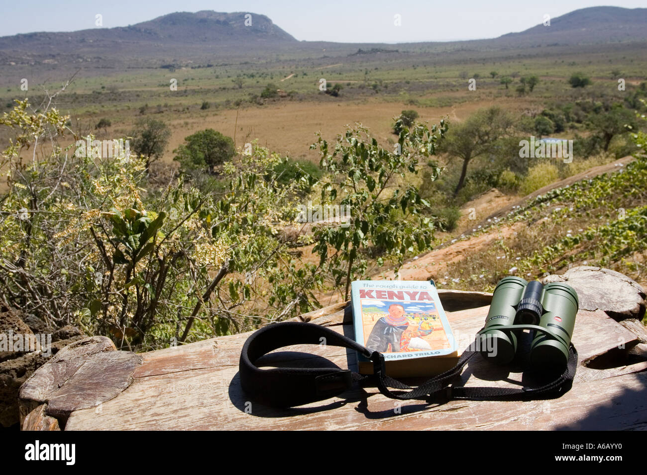Binoculars and Kenya guide book on table on veranda at Ngulia Bandas in Tsavo National Park West Kenya East Africa Stock Photo